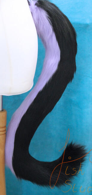 A longer style of cat tail reaching to about knee height on the average adult. The top part is black, the underside is lilac. The colours can be changed to suit your character's needs. Great for costumes, cosplay fursuits and larping