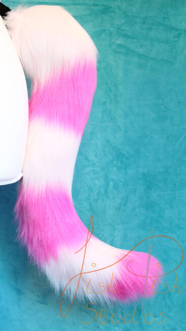 A bright and pale pink alternating striped cat tail. Approx 17 inches long, this is great for furries, therians and cosplays. Design is based on the famous Cheshire Cat, but colours can be changed to suit. handmade in the UK by fishpish studios