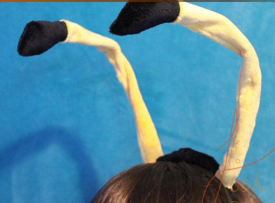 A bumble bee coloured version of the bud tipped antenna available in store. Made of yellow and black fabric. The antenna has a wire core for posing and is on a headband. handmade by fishpish studios in the UK