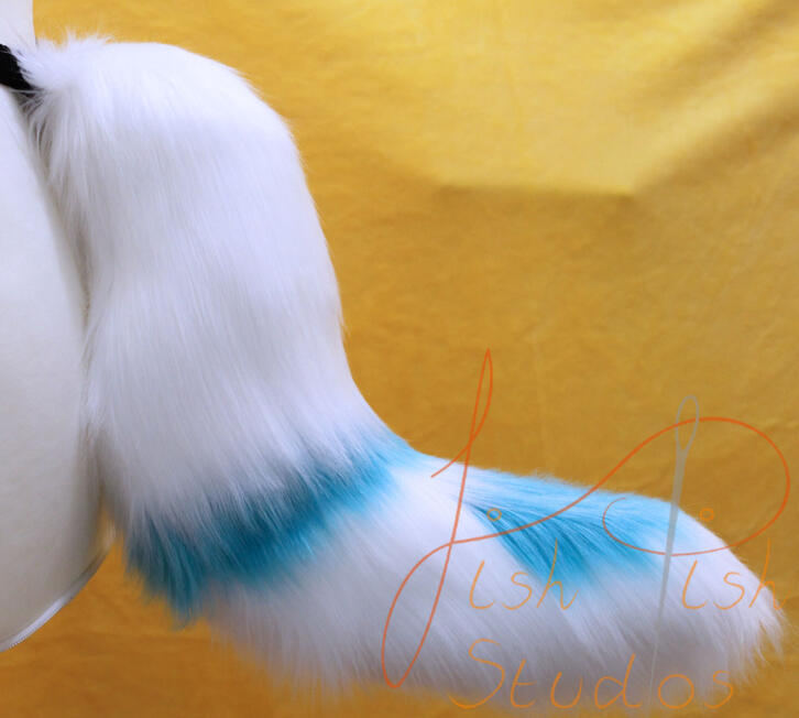 A customised white and turquoise wild dog fursuit tail, these tails can also be used for larp or therian designs. made of luxury faux fur by fishpish studios