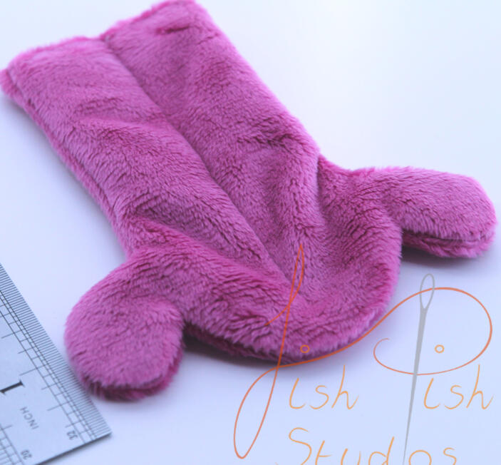 A close up image of a fursuit tongue made by fishpish studios. this tongue is about 5 inches long in a customised drippy style. its made with soft plush fabric and is ideal for fursuit heads