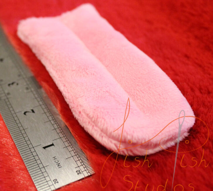 A close up image of a fursuit tongue made by fishpish studios. this tongue is about 5 inches long in the straight style. its made with soft plush fabric and is ideal for fursuit heads