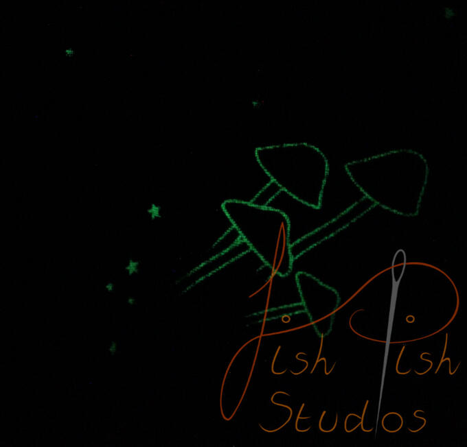 a close up showing the glowing musrooms and stars on the fursuit bandana. The fabrics are polycotton. The design is XL at 36 inches, making it a great fashion accessory or something to decorate your fursuit. handmade in the UK by fishpish studios