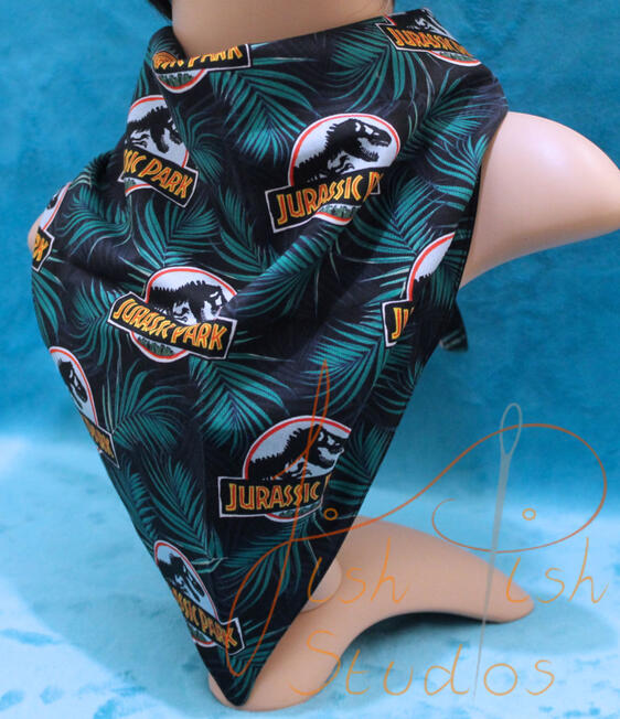 an XL bandana with a jurassic park print. The fabrics are polycotton. The design is XL at 36 inches, making it a great fashion accessory or something to decorate your fursuit. handmade in the UK by fishpish studios