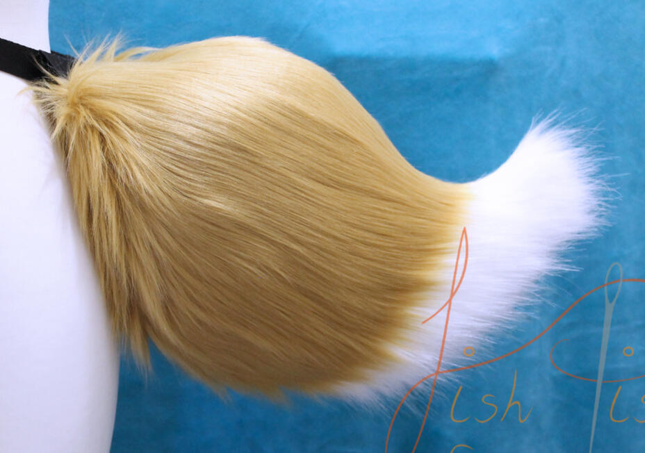 A luxury faux fur demon fox tail, this one in caramel and white. It's soft fabric is smooth the the touch and can be customised in a variety of colours available in the store. Handmade by fishpish studios in the UK