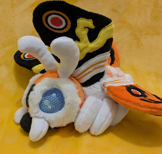 Mothra Plushie a handmade, highly detailed mothra plushie. This design comprises of applique, hand sewn parts, various fabrics and a very cute face. Made by fishpish studios in the UK